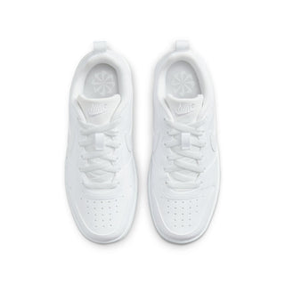 Youth white low-top sneakers, top view with perforated toe and Nike logo