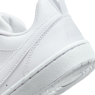 White sneaker side close-up with Nike swoosh detail and textured midsole