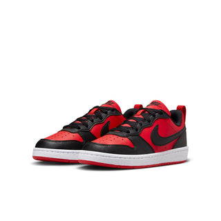 Youth red, black, and white low-top sneakers, side view with black swoosh and white sole.