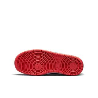 Youth sneaker outsole in red with circular traction pattern and textured tread.