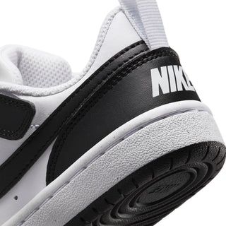 Kids sneaker heel close-up with NIKE text on black panel and textured rubber sole