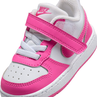 Toddler sneaker close-up: white leather and laser fuchsia straps with stitched details