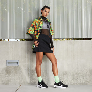 Woman wearing black Nike Air Max INTRLK Lite sneakers with white soles