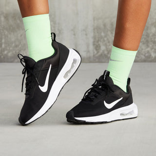 Black Nike Air Max INTRLK Lite sneakers worn with mint socks