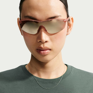 Women’s dark green crew-neck tee close-up with Nike logo on chest
