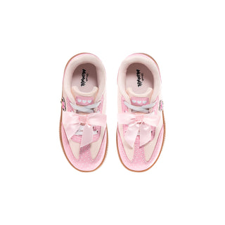 Pair of pink toddler sneakers with Minnie print and satin bow at laces