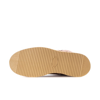 Men’s boot outsole with tan ribbed tread and rounded toe edge