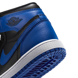 Kids high-top sneaker detail: royal blue leather panel with wing logo and white outsole