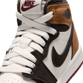Close-up of kids high-top sneaker laces and tongue; black swoosh and brown collar