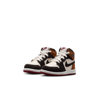 Pair of toddler high-top sneakers in white, black, and brown with red outsole