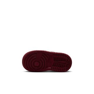 Outsole view of toddler high-top sneakers with grippy red traction tread