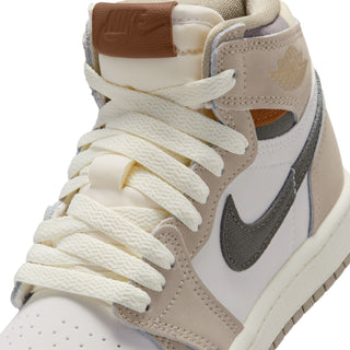 Kids high-top sneaker close-up of off-white laces, beige overlays, and brown heel lining