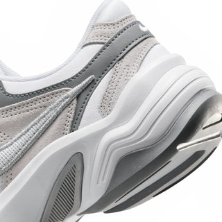 Close-up of white and gray sneaker midsole with sculpted cushioning and side vents