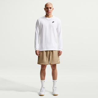 Men's parachute beige shorts worn with a white long-sleeve shirt