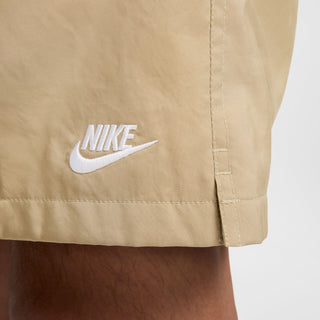 Parachute beige shorts with white Nike logo on the lower front