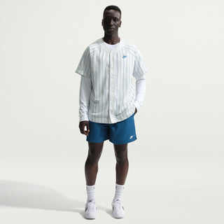 Men's blue drawstring shorts with elastic waistband, shown on-model with shoes