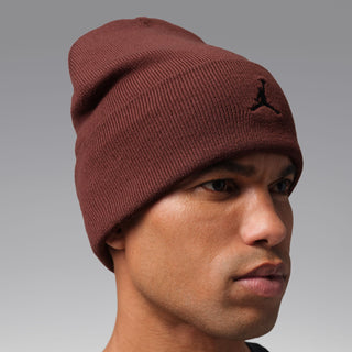 Maroon knit beanie with Jordan logo patch, side view worn on model