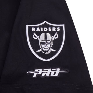 Close-up of Raiders shield logo and short 'PROD' text on black T-shirt sleeve