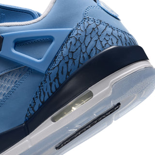 Close-up of blue sneaker heel with patterned overlay and visible Air cushioning.