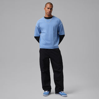 Blue Jordan Spizike Low men's sneakers worn with black trousers.