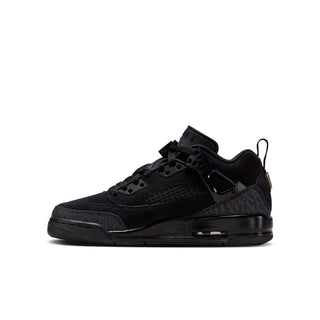 Youth black low-top sneakers in side profile, featuring lace-up straps and molded details