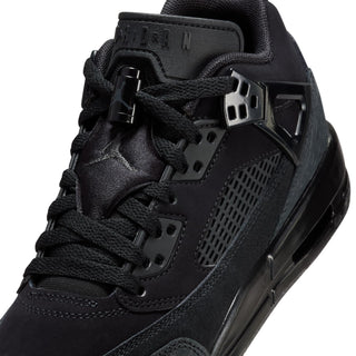 Close-up of youth black sneaker upper with lace eyelets, straps, and mesh detail