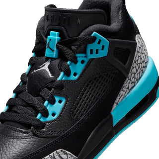 Youth low-top sneakers close-up: black leather, grey print, aqua lace hardware
