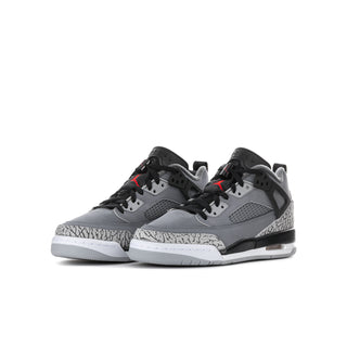 Youth low-top sneakers, cool grey with black overlays, red accents, and speckled side