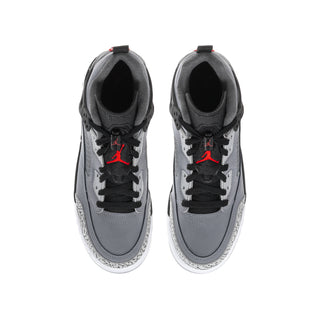 Youth low-top sneakers showing inner view: black lining, cool grey panels, red lace tags