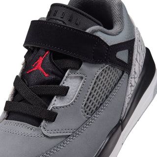 Kids' sneaker close-up: black hook-and-loop strap, gray mesh, and red Air Jumpman detail.