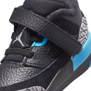Kids black sneaker close-up with blue lace detail and grey mesh side panel