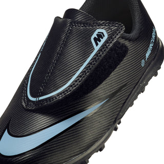 Kids soccer cleat upper close-up, black textured fabric with blue Nike swoosh