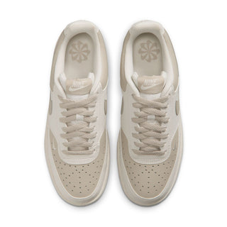Pair of cream low-top sneakers showing padded tongue and insole branding