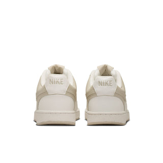 Women's cream low-top sneakers with Nike-branded heel tabs and padded collar