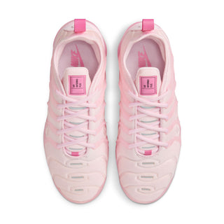 Pink women's sneakers viewed from above, showing lace-up closure and cushioned tongue