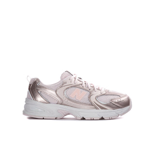 Youth running sneaker in light pink and white, lace-up with cushioned sole.
