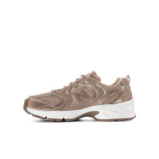 Youth lace-up running shoe side view in taupe with N emblem and padded tongue.