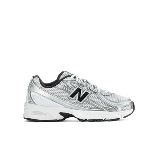 Youth athletic sneakers, silver metallic upper with black N logo and low tread sole