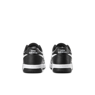 Youth black/white sneaker with rear New Balance logo and heel tab