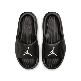 Youth black slip-on slides with white Jumpman logos, top view