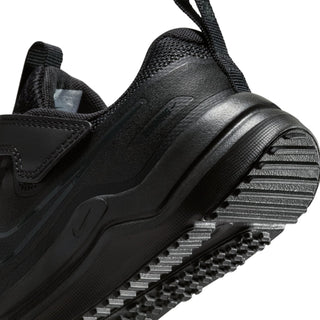 Close-up of kids black running shoe outsole tread and textured midsole