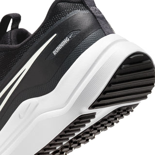 Youth running shoe side view close-up with white midsole cushioning and ribbed outsole