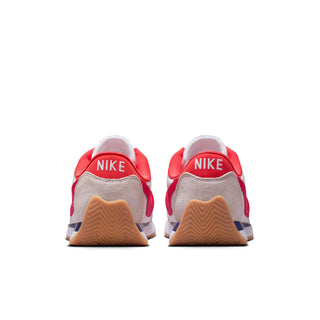 Women's low-top sneakers heel view with red tab and Nike branding, gum sole