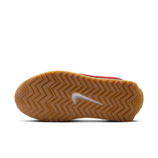 Women's sneaker outsole with gum rubber tread and blue Nike swoosh