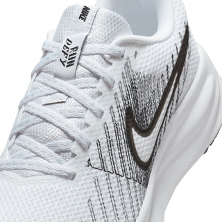 Women's white running shoe upper close-up with lace, knit texture, and black Swoosh