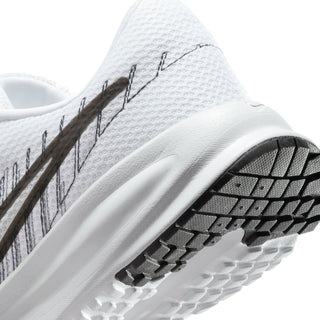 White women's running shoe, close-up of side texture and black-and-white outsole