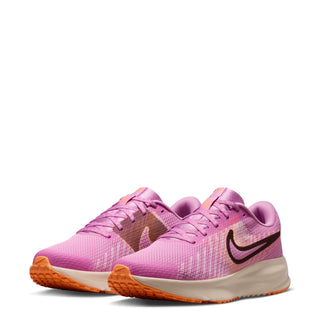 Pink running sneakers with lace-up front, visible Nike swoosh, cream midsole
