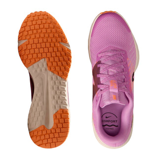 Outsole and insole of pink running shoe: orange tread, Nike logo