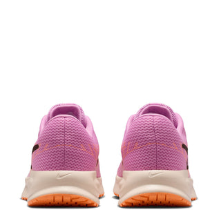 Back view of pink lace-up running shoes with cream heel and orange outsole