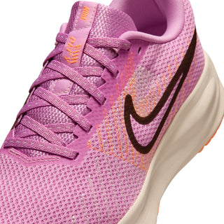Close-up of pink knit upper with black Nike swoosh and purple laces